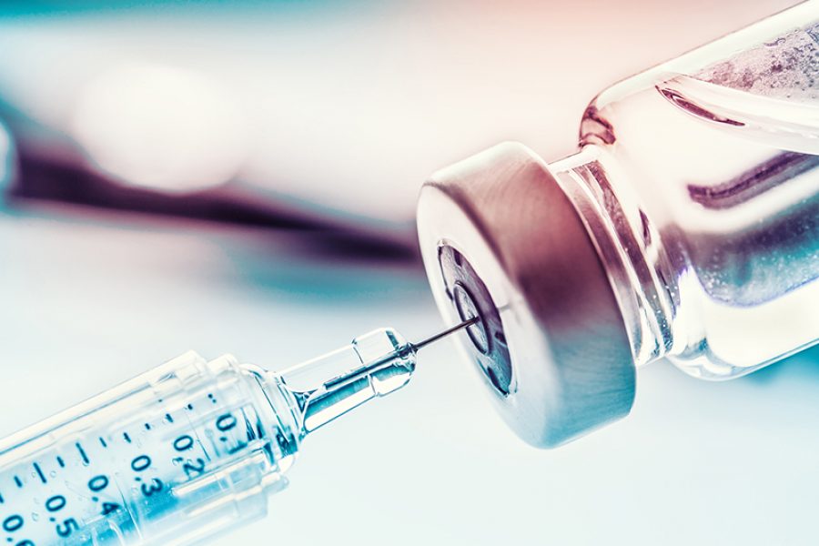 Close up medical syringe with a vaccine.