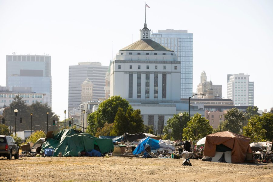 A,Homeless,Encampment,Frames,The,Skyline,Of,Downtown,Oakland,,California,